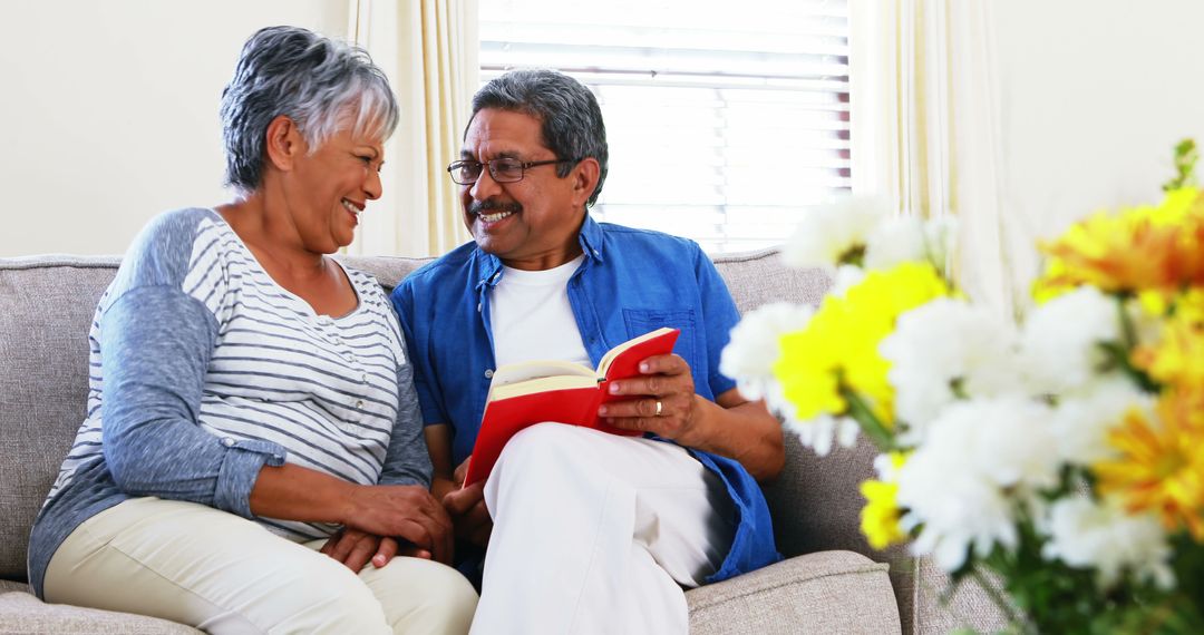 Joyful Elderly Couple Reading Book Together - Free Images, Stock Photos and Pictures on Pikwizard.com