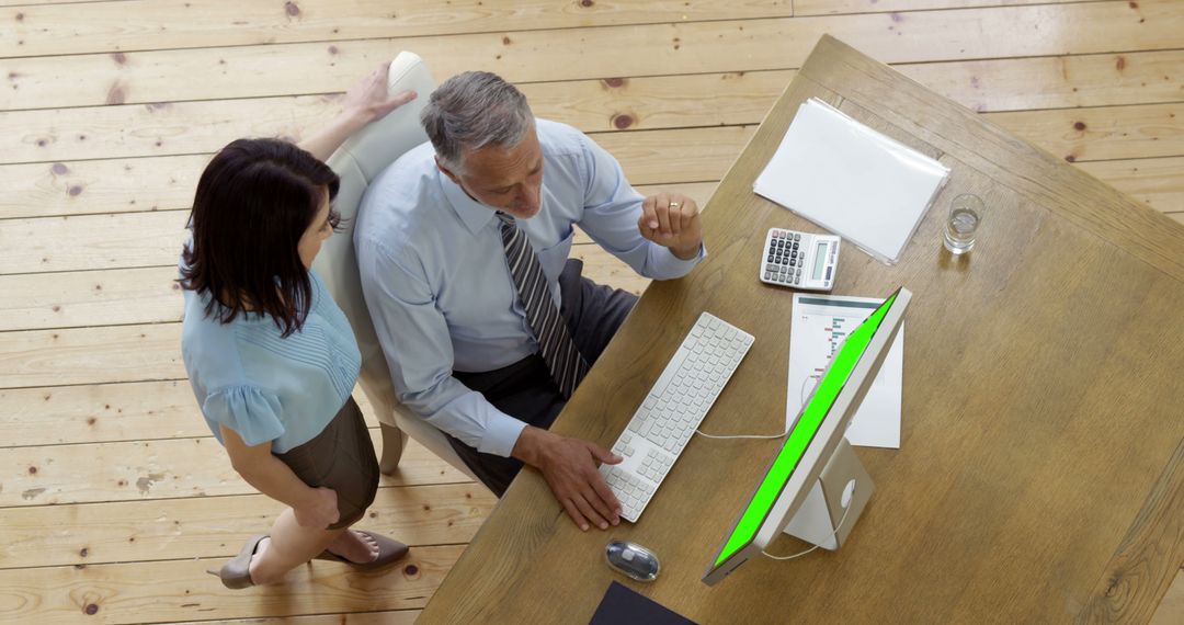 Corporate Team Discussing Work at Desk with Computer