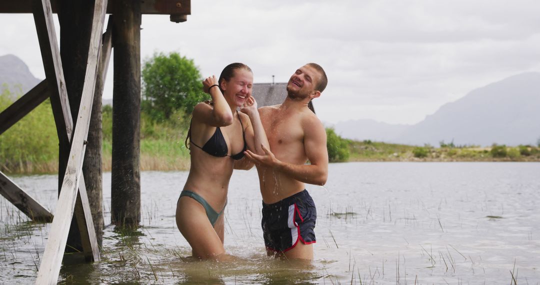 Couple Enjoying Playful Moment in Lake While Bathing - Free Images, Stock Photos and Pictures on Pikwizard.com