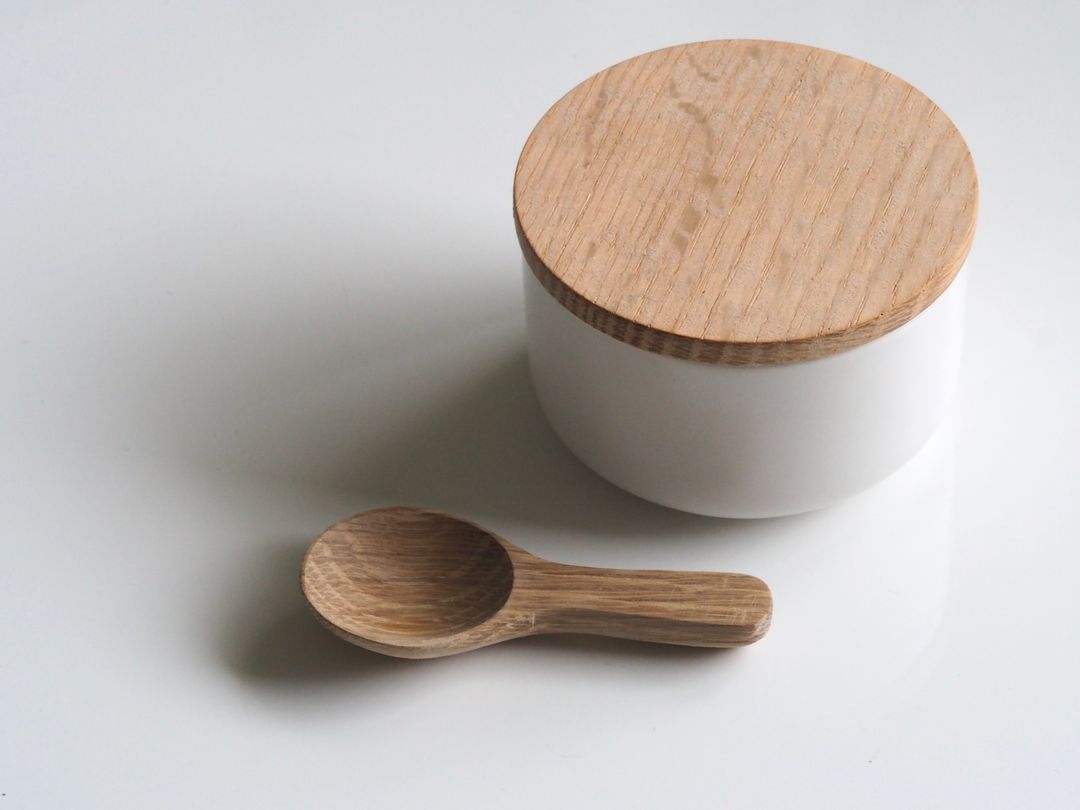 Minimalist Wooden Lid Ceramic Jar and Spoon on White Background