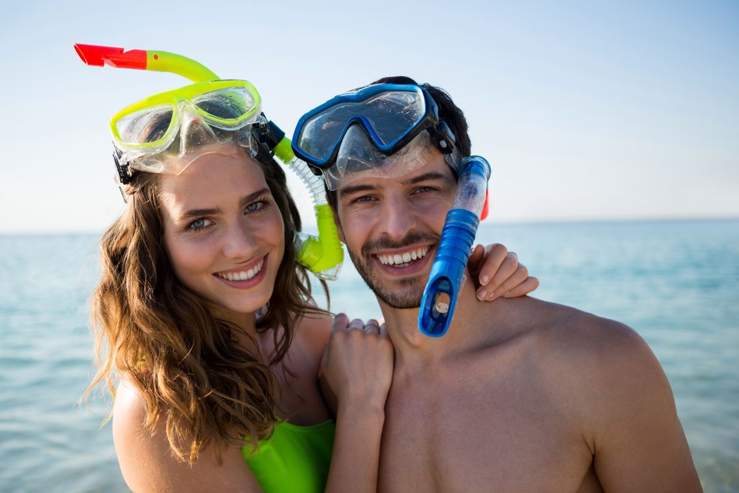 Smiling Young Couple Wearing Scuba Masks at Beach - Free Images, Stock Photos and Pictures on Pikwizard.com