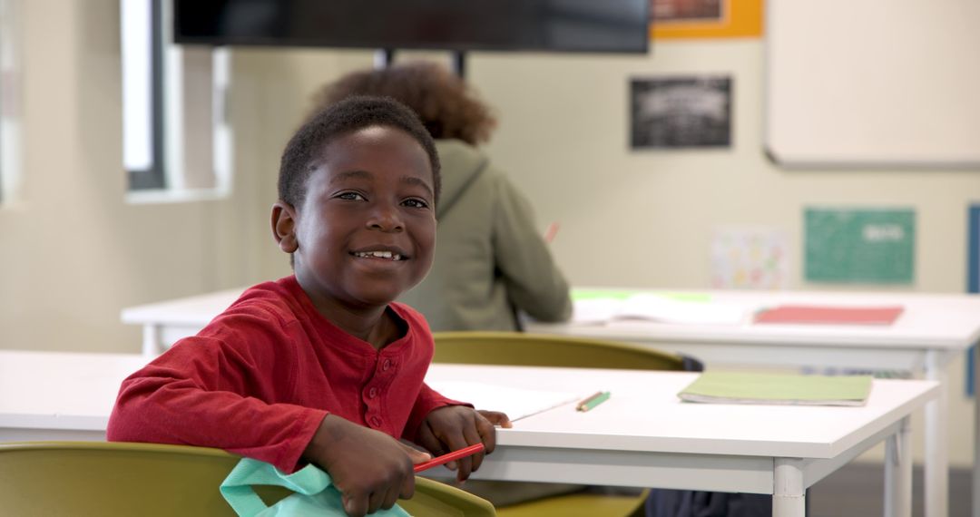 Smiling Child Learning in Classroom Encourages Educational Engagement