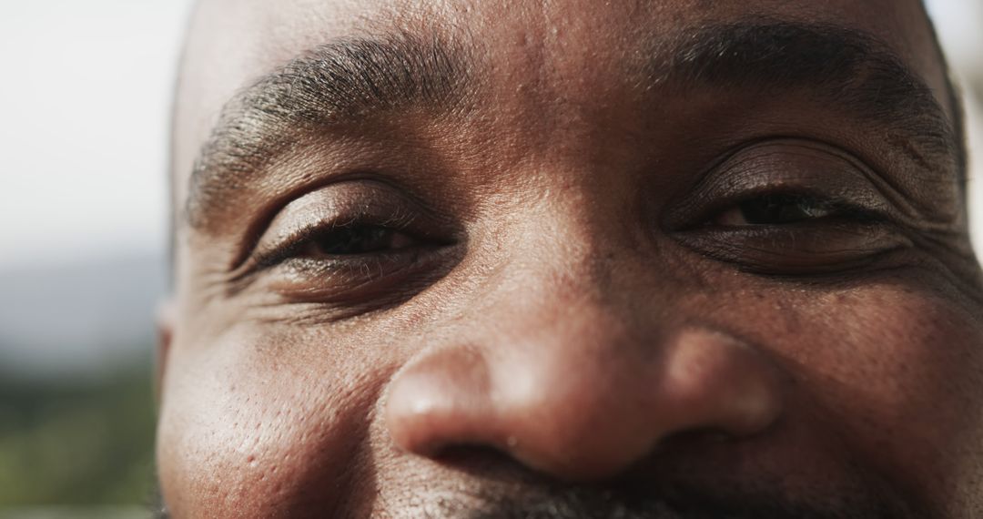 Close-Up of Smiling Man's Face with Deep Eye Gaze - Free Images, Stock Photos and Pictures on Pikwizard.com