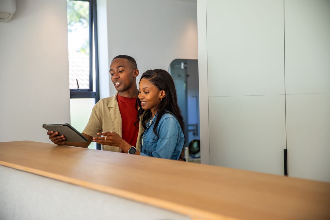 African American Couples Using Tablet at Reception Desk