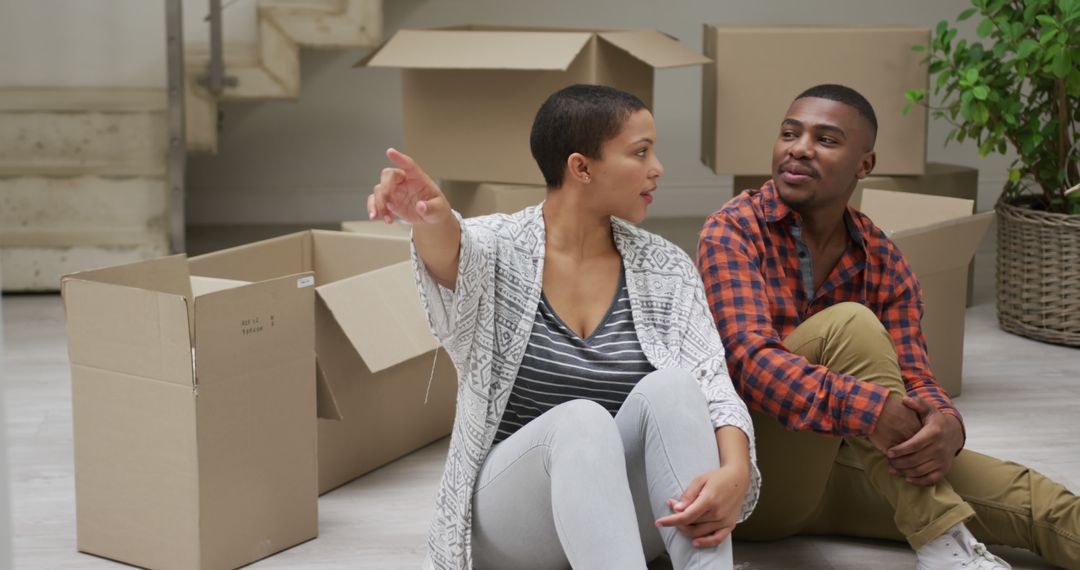 Couple Enjoying Moving Day Amidst Cardboard Boxes - Free Images, Stock Photos and Pictures on Pikwizard.com