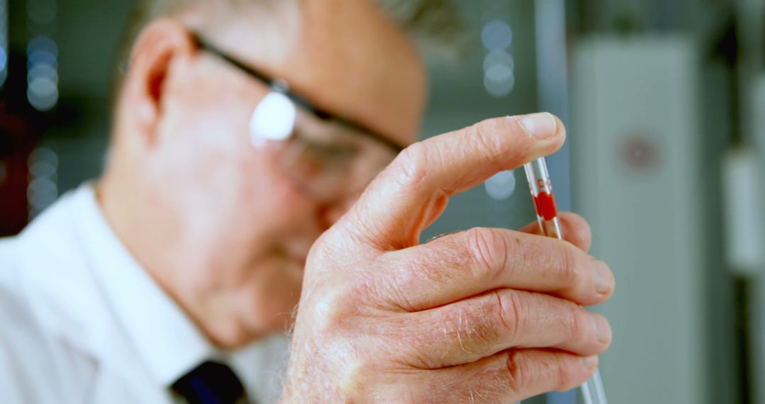 Senior Scientist Holding Test Tube with Red Liquid in Laboratory - Free Images, Stock Photos and Pictures on Pikwizard.com