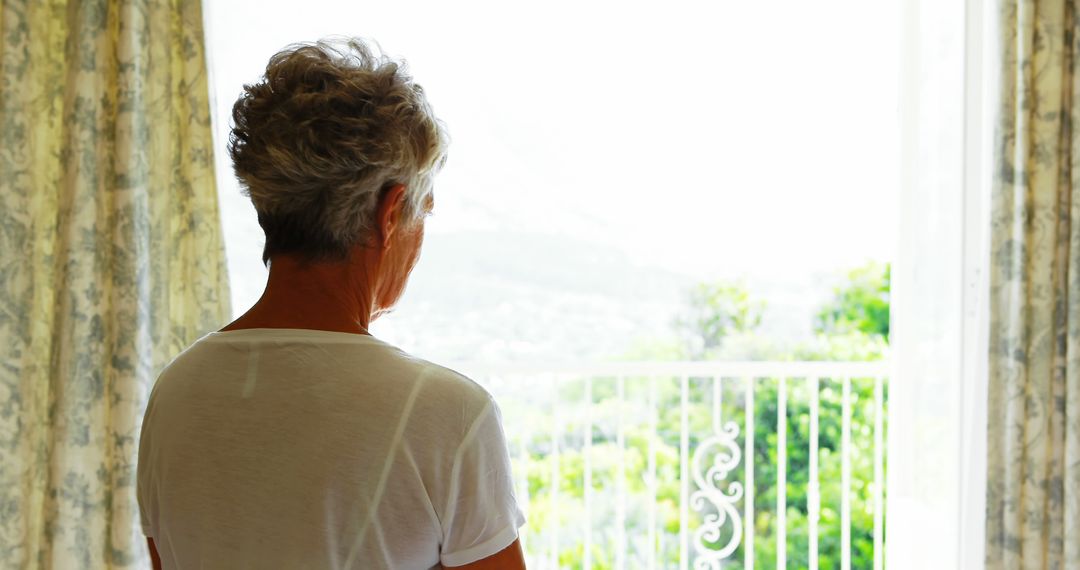 Elderly Woman Looking Out Window with Scenic View - Free Images, Stock Photos and Pictures on Pikwizard.com