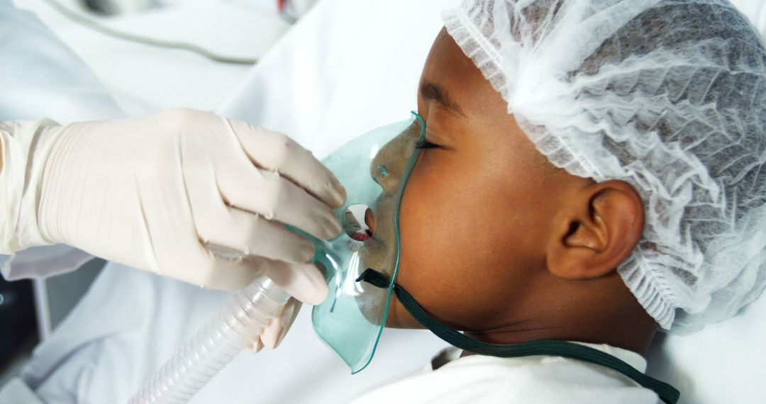 Healthcare Worker Placing Oxygen Mask on Child Patient - Free Images, Stock Photos and Pictures on Pikwizard.com