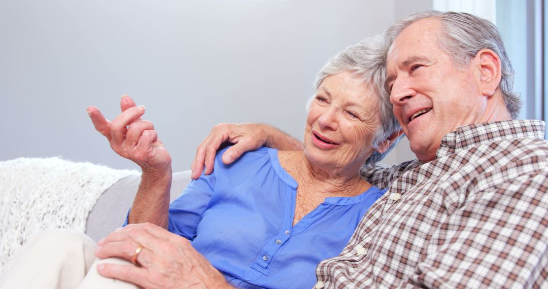 Cute elderly couple talking on sofa - Free Images, Stock Photos and Pictures on Pikwizard.com