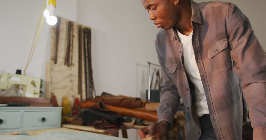Focused Craftsman Brushing Leather in Artisan Workshop