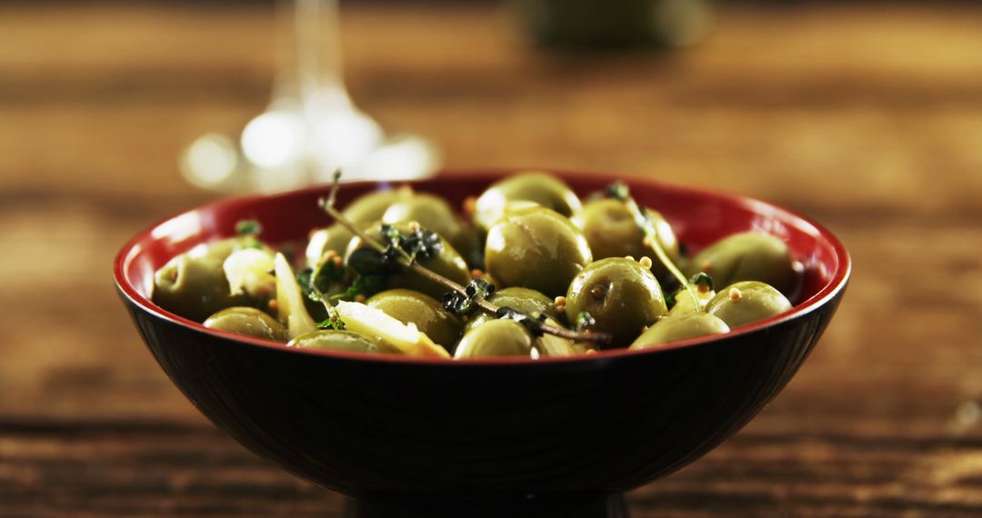 Close-Up of Marinated Olives in Black Bowl on Wooden Table - Free Images, Stock Photos and Pictures on Pikwizard.com