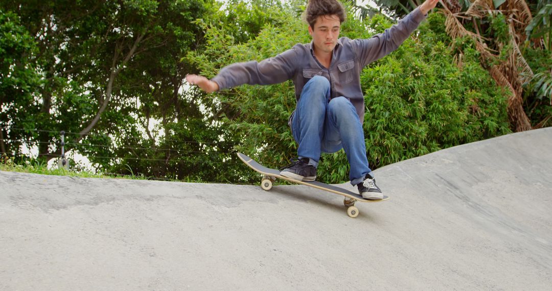 Young Man Skateboarding at Concrete Skate Park - Free Images, Stock Photos and Pictures on Pikwizard.com