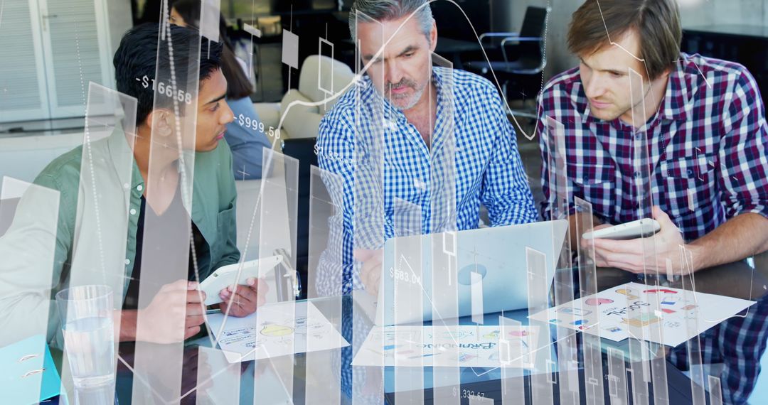Business Team Analyzing Financial Graphs and Technology in Office Meeting