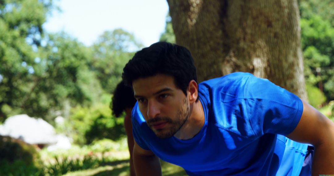 Man in Blue Shirt Exercising in Park - Free Images, Stock Photos and Pictures on Pikwizard.com