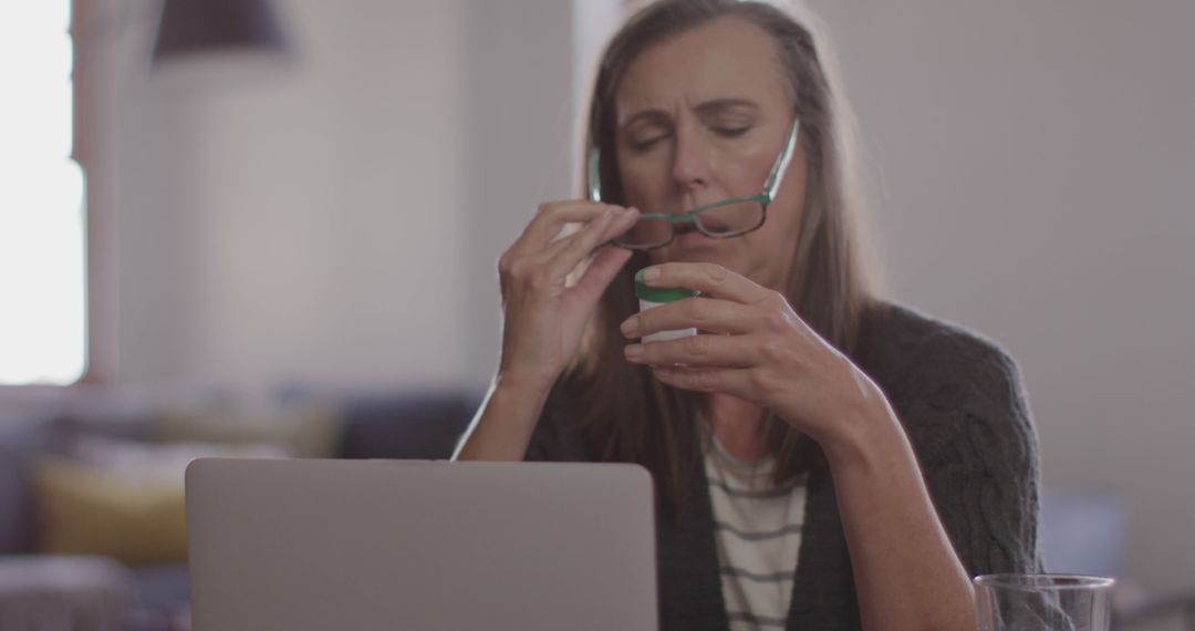 Elderly Woman Drinking from Cup While Using Laptop at Home - Free Images, Stock Photos and Pictures on Pikwizard.com