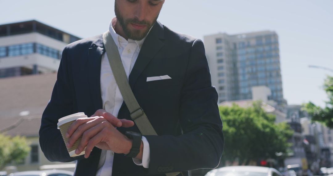 Businessman Checking Smartwatch on Busy City Street - Free Images, Stock Photos and Pictures on Pikwizard.com