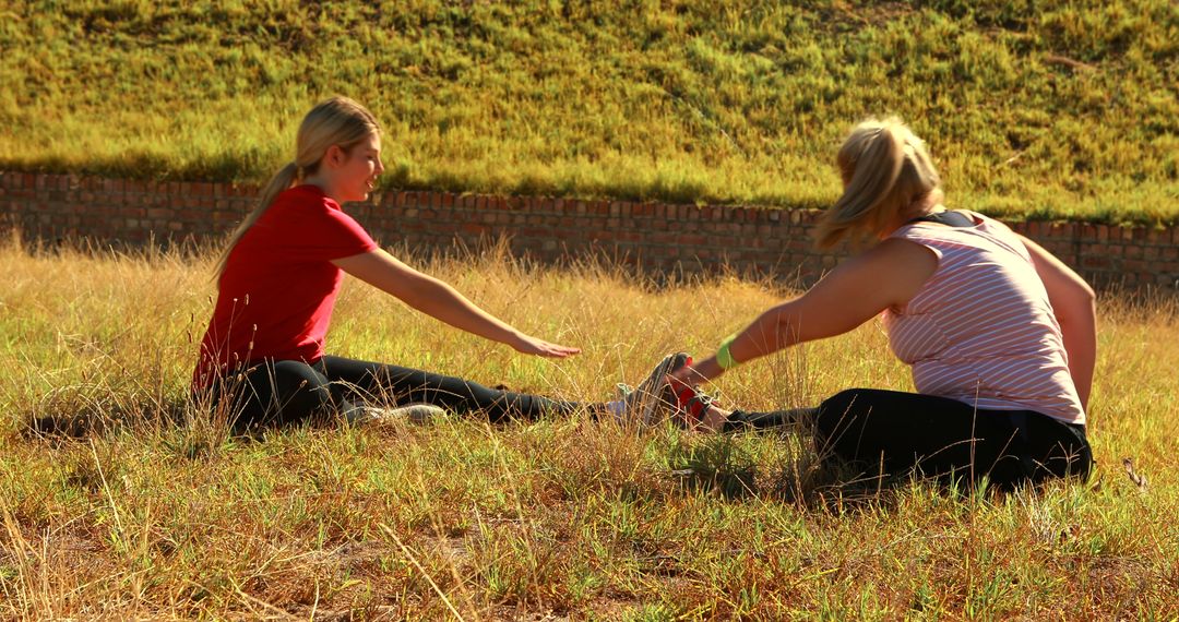 Women stretching in the park on a sunny day - Free Images, Stock Photos and Pictures on Pikwizard.com