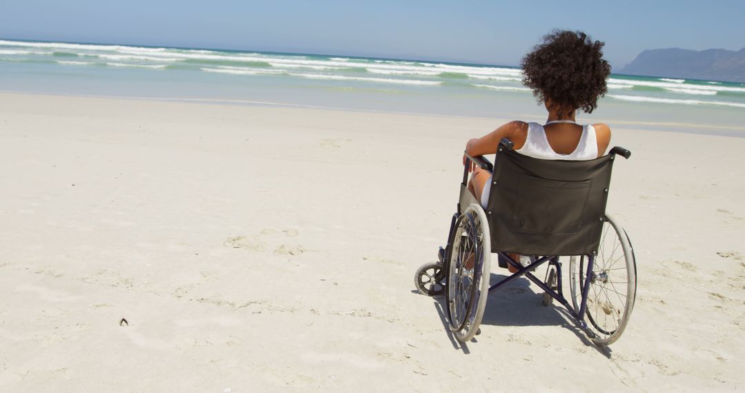 Person in Wheelchair Enjoying Scenic View at Beach - Free Images, Stock Photos and Pictures on Pikwizard.com