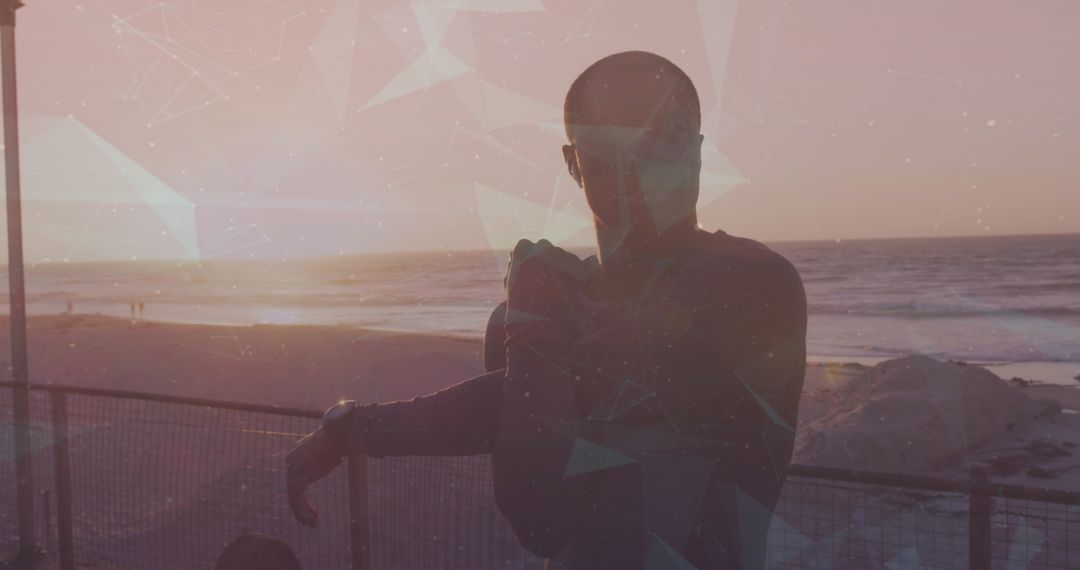 Silhouette of Man Stretching on Beach at Sunset with Digital Overlay