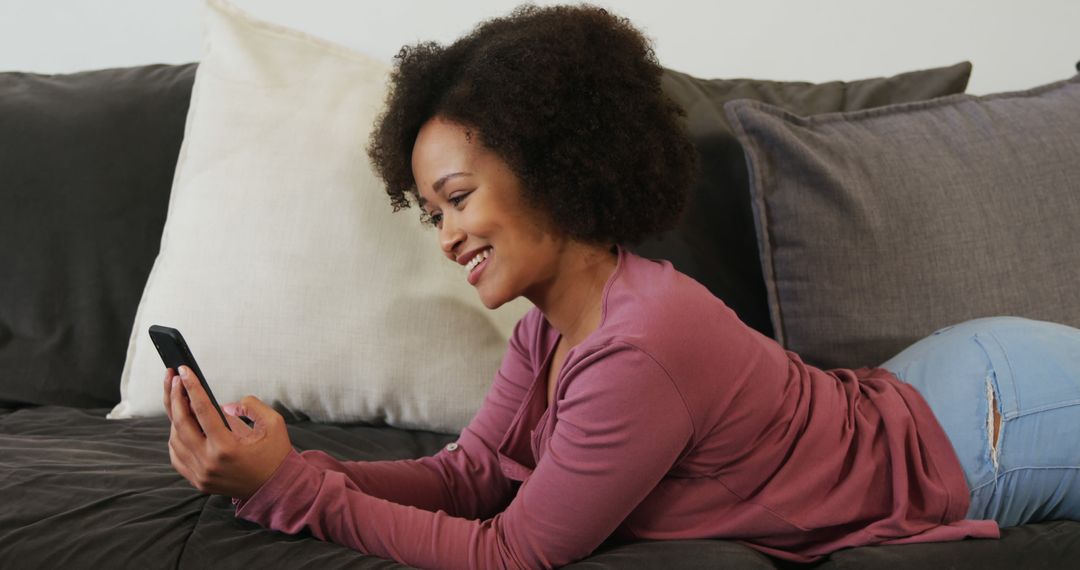 Smiling Woman Relaxing on Sofa Using Smartphone - Free Images, Stock Photos and Pictures on Pikwizard.com