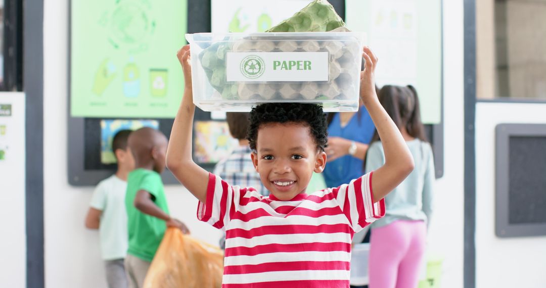 Smiling Boy Holding Recycling Bin During School Recycling Activity