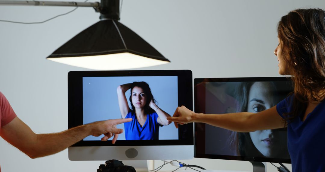 Photographers Reviewing Portrait on Monitor Screen in Studio - Free Images, Stock Photos and Pictures on Pikwizard.com