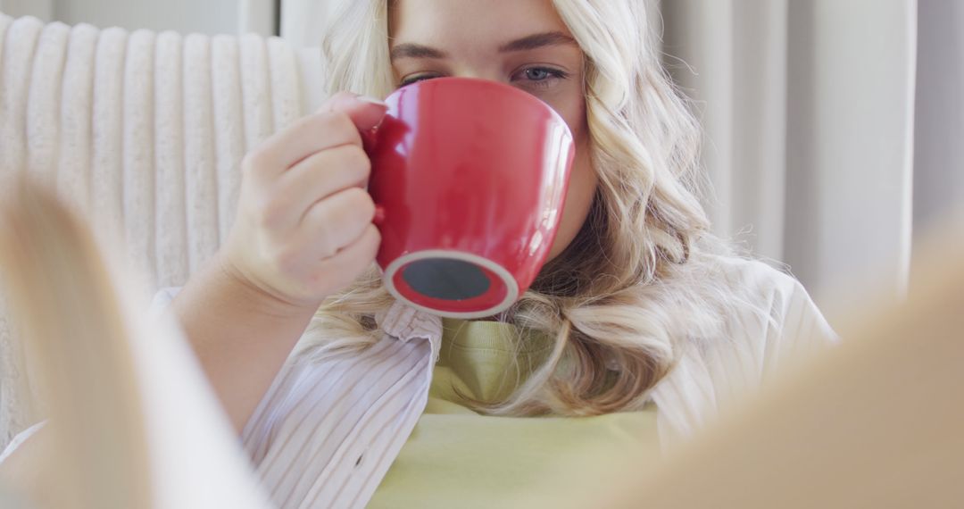 Woman Relaxing at Home Drinking Coffee from Red Mug - Free Images, Stock Photos and Pictures on Pikwizard.com