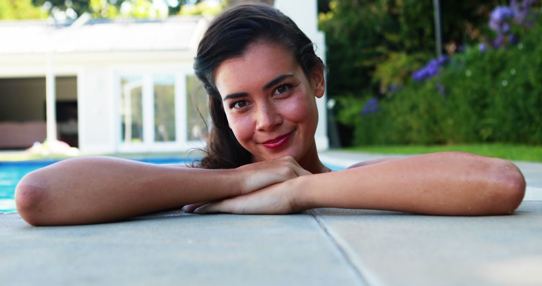 Smiling Woman Relaxing by Poolside Enjoying Sunny Day