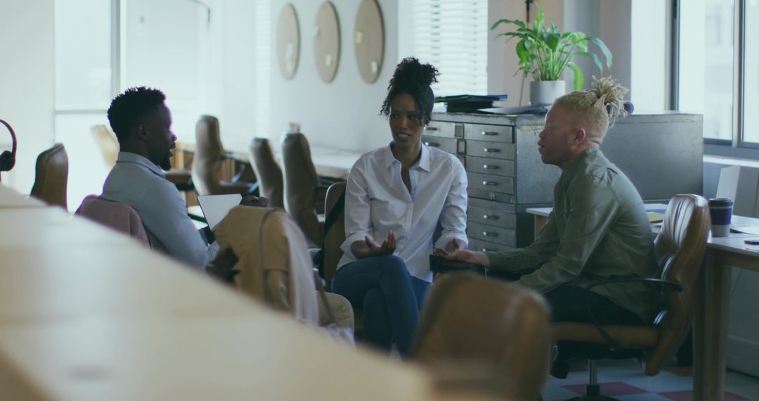Colleagues Collaborate in Open-Plan Office Setting