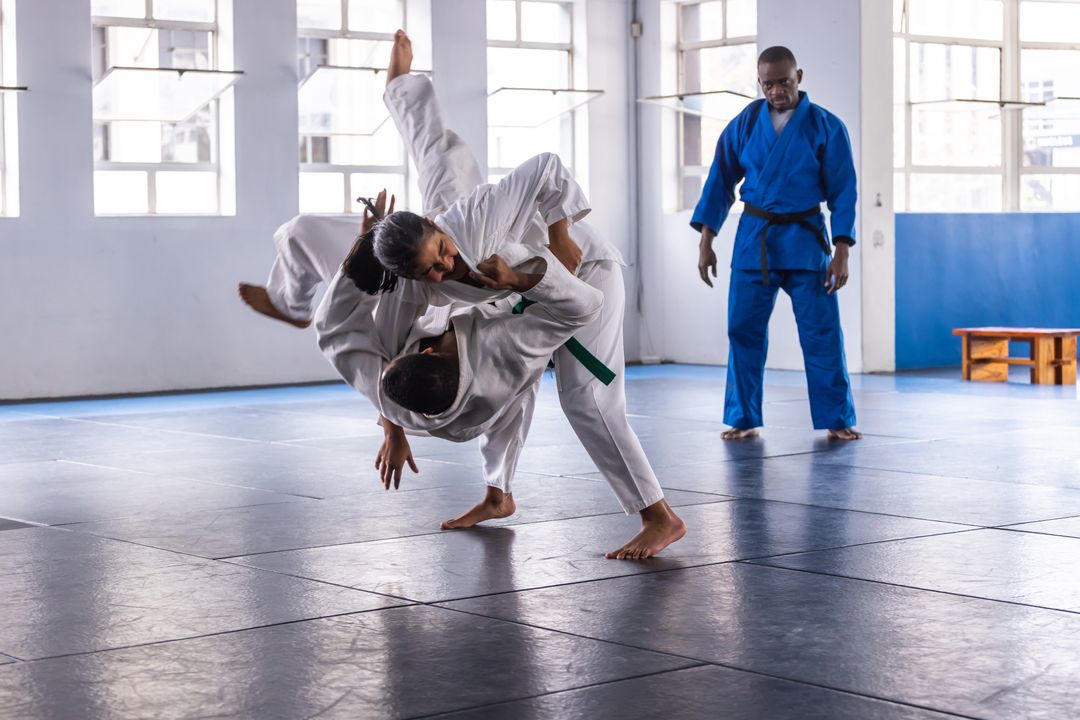 Diverse Judo Class Practicing Throws in Dojo