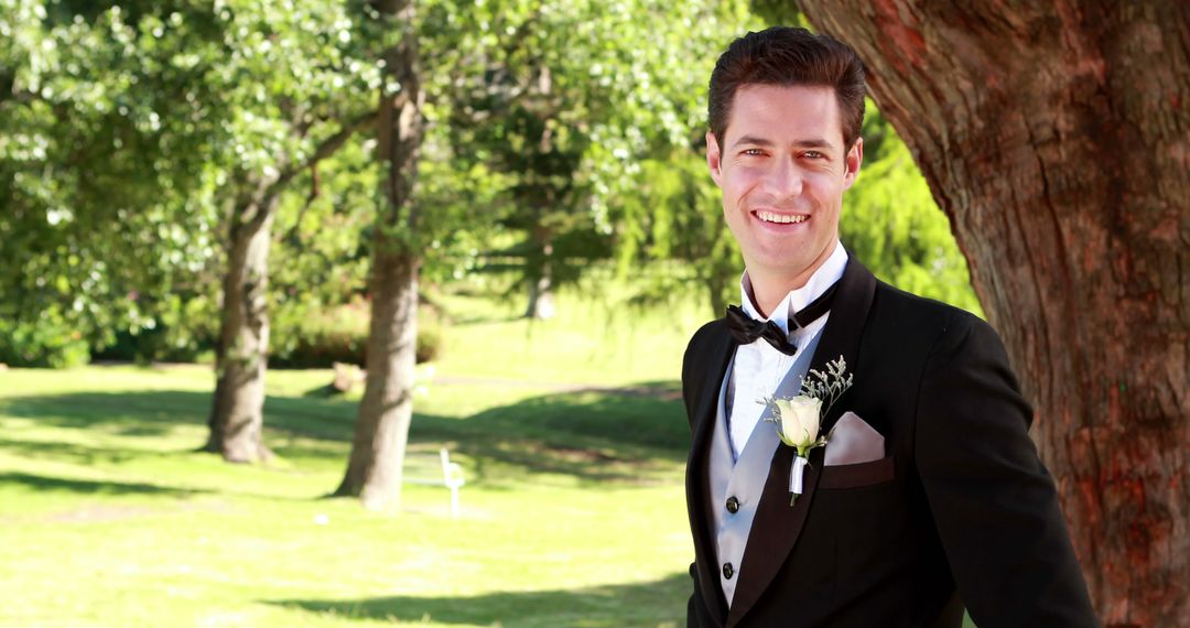 Smiling Groom Standing Outdoors on a Sunny Wedding Day - Free Images, Stock Photos and Pictures on Pikwizard.com