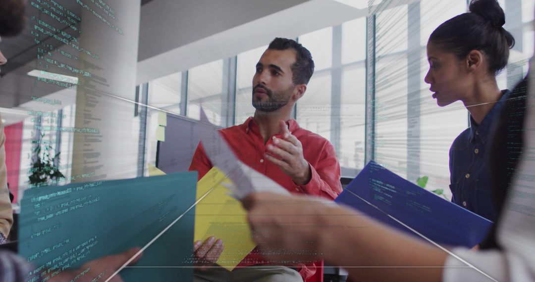 Colleagues Engaging in Strategic Discussion Surrounded by Code Interface