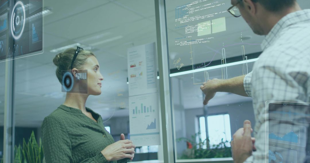 Colleagues Analyzing Data Visualizations in Modern Office Setting