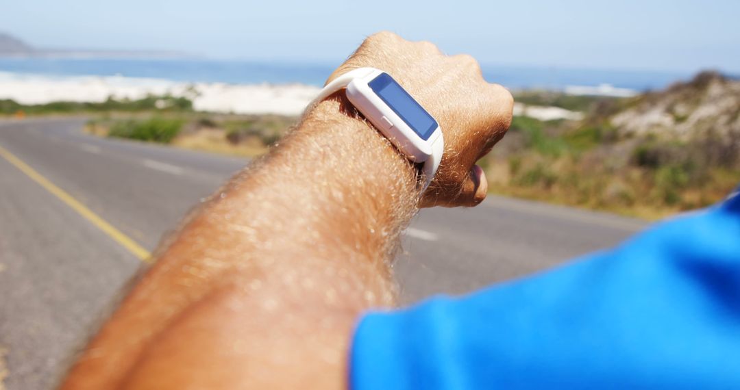 Athlete Checking Smartwatch for Fitness Tracking During Outdoor Run - Free Images, Stock Photos and Pictures on Pikwizard.com