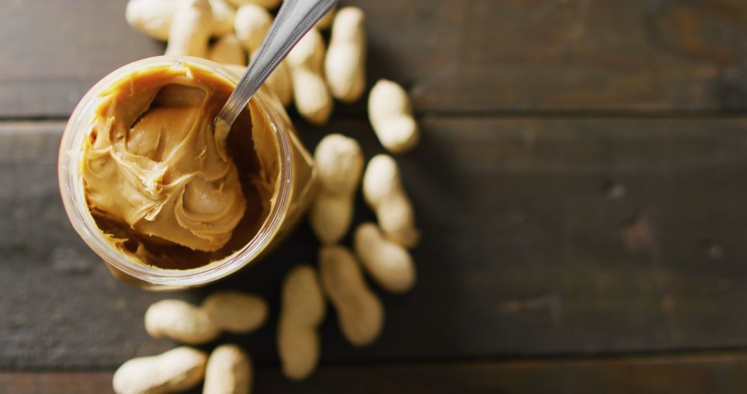 Creamy Peanut Butter with Peanuts on Rustic Wooden Surface - Free Images, Stock Photos and Pictures on Pikwizard.com