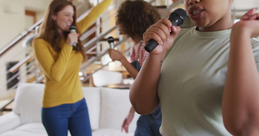 Group of Young Women Singing Karaoke at Home, Having Fun Together - Free Images, Stock Photos and Pictures on Pikwizard.com