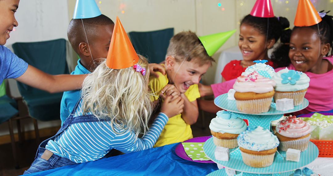 Children Celebrating Birthday with Laughter and Cupcakes - Free Images, Stock Photos and Pictures on Pikwizard.com