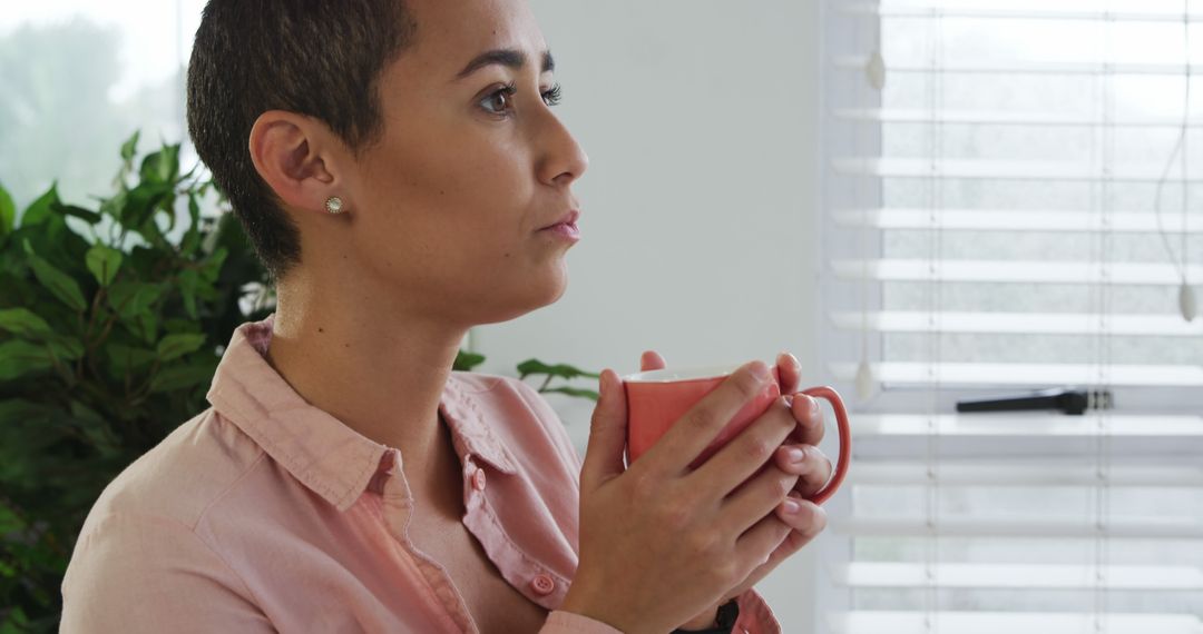 Young Woman with Short Hair Relaxing with Coffee at Home - Free Images, Stock Photos and Pictures on Pikwizard.com