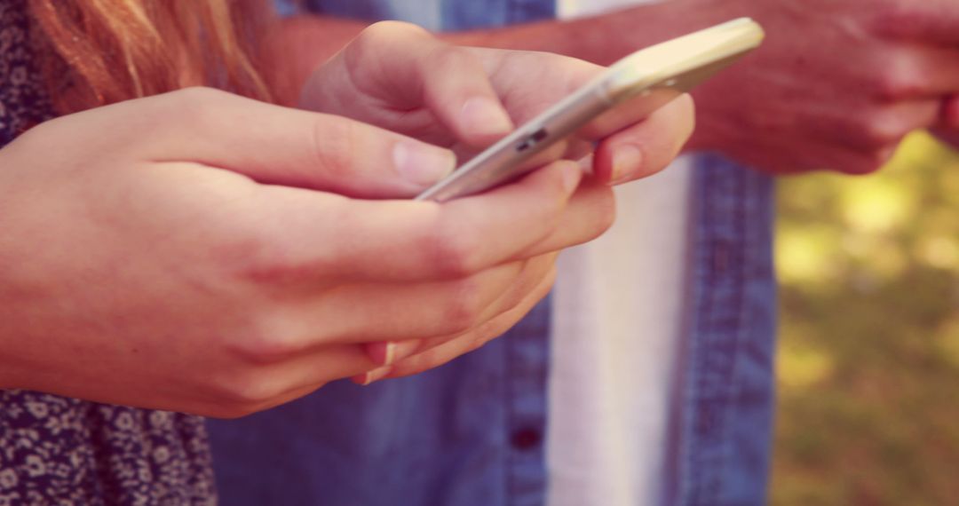 Close-up of Friends Texting on Smartphones Outdoors - Free Images, Stock Photos and Pictures on Pikwizard.com