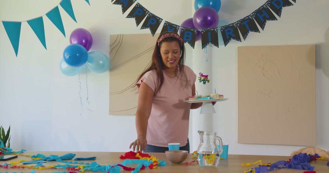 Smiling Woman Arranging Colorful Birthday Decorations at Home