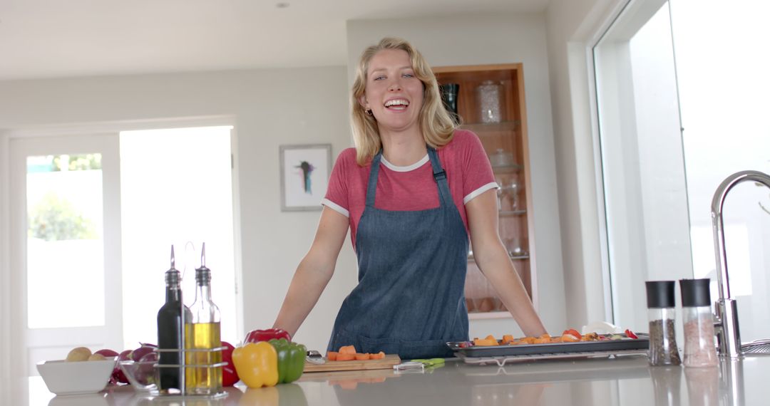 Smiling Woman Cooking Vegetables in Modern Kitchen - Free Images, Stock Photos and Pictures on Pikwizard.com