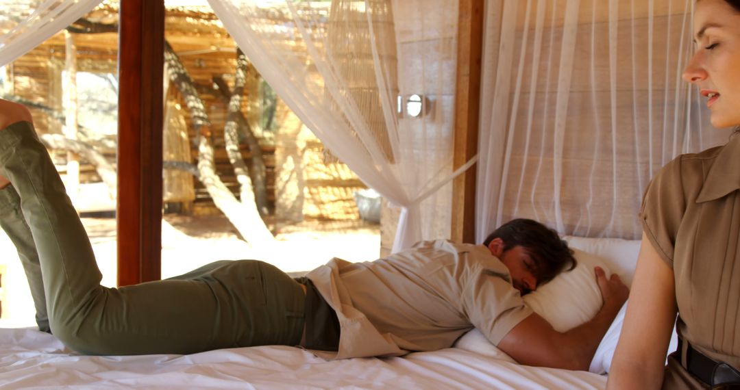 Relaxed Man Lying on Bed in Outdoor-Cabin with Natural Light - Free Images, Stock Photos and Pictures on Pikwizard.com