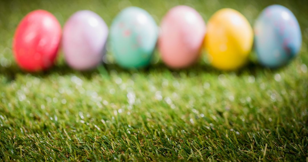 Colorful Easter Eggs Lined Up on Fresh Green Grass