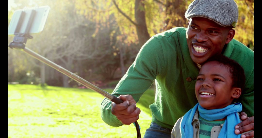 Happy African American Father and Son Taking Selfie in Park - Free Images, Stock Photos and Pictures on Pikwizard.com