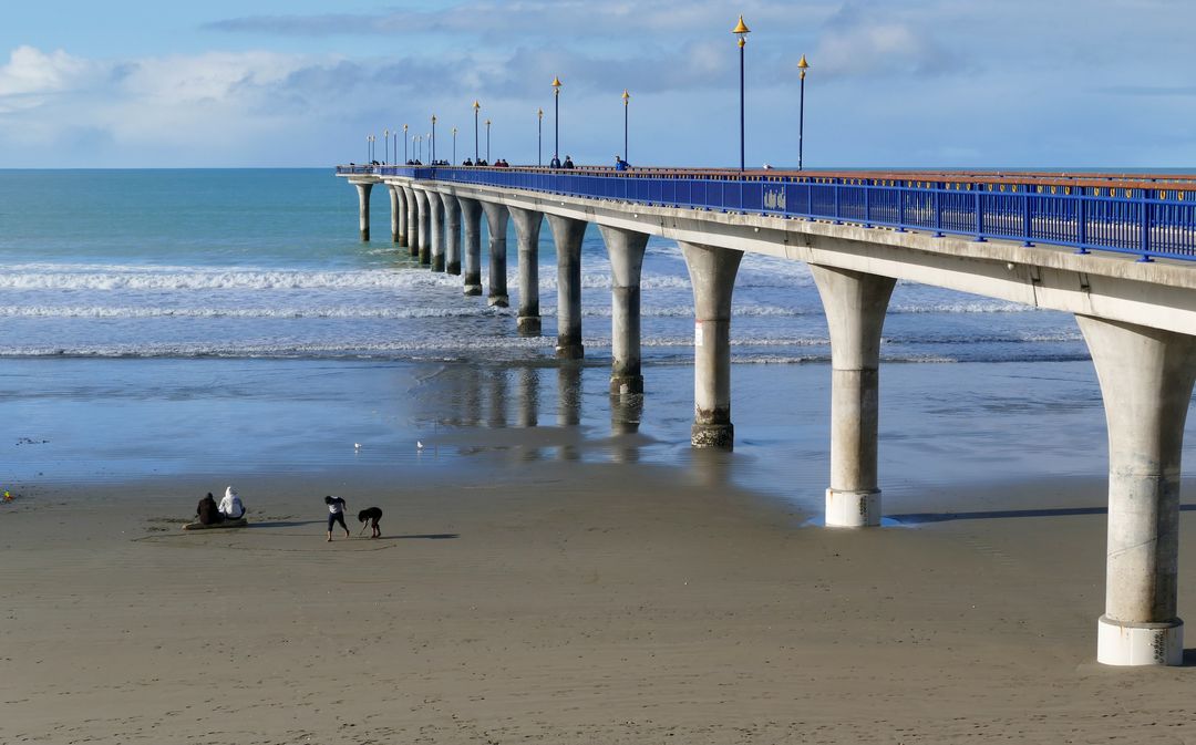 Long Beach Pier Overlooking Ocean with Figures on Sand