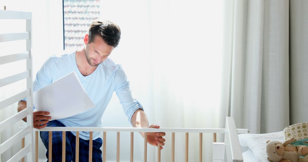 Father Assembling Baby Crib in Bright Modern Nursery - Free Images, Stock Photos and Pictures on Pikwizard.com