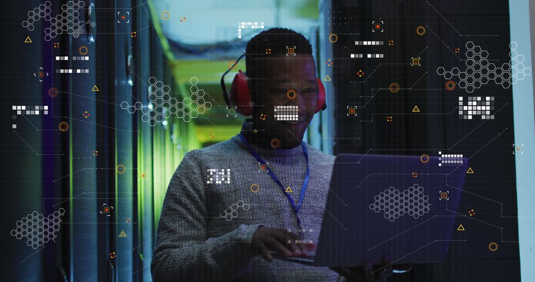 Engineer Analyzing Data with Laptop in High-Tech Server Room