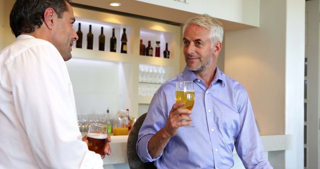 Two Mature Men Enjoying Beer in a Cozy Bar - Free Images, Stock Photos and Pictures on Pikwizard.com