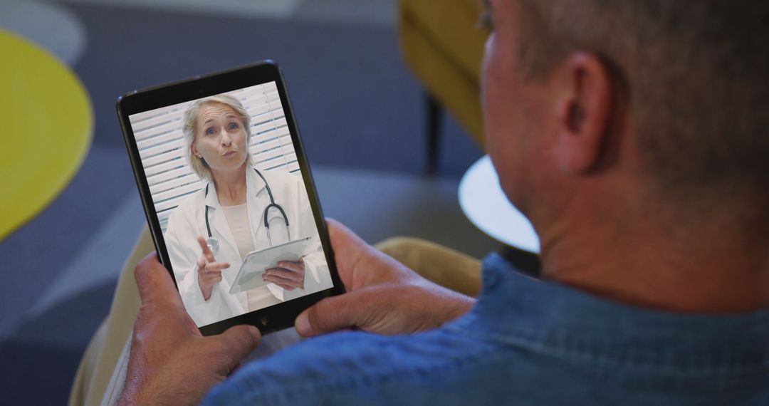 Senior Man Video Chatting with Doctor on Tablet