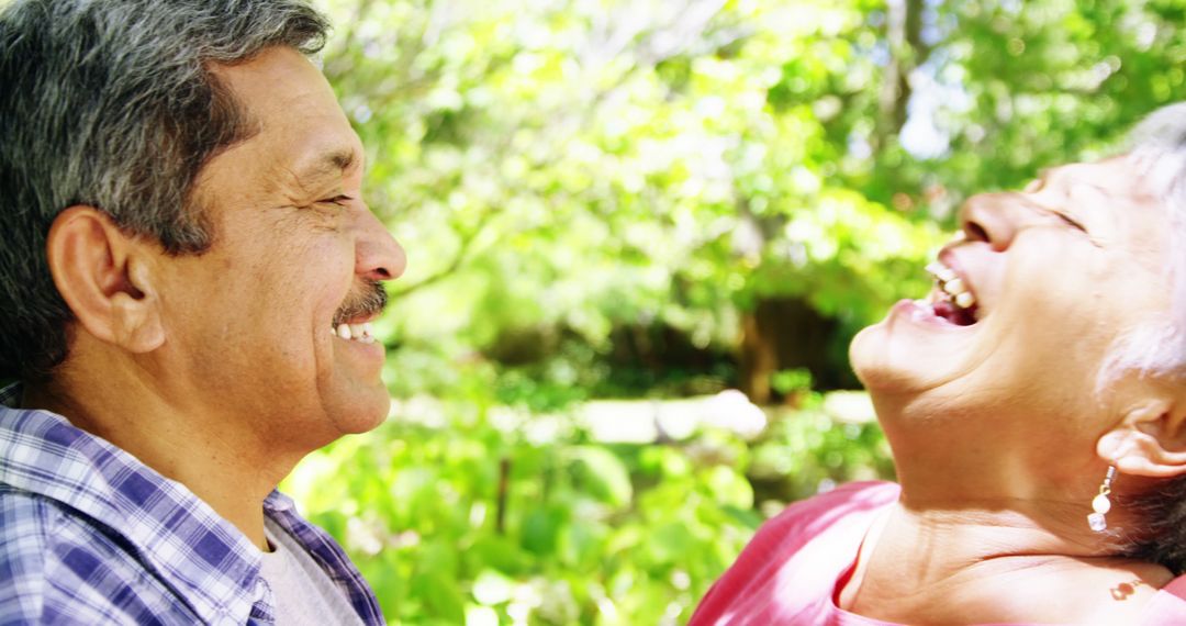 Senior Couple Laughing Together Outdoors on Sunny Day - Free Images, Stock Photos and Pictures on Pikwizard.com